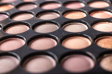 eye shadow is close. A makeup brush with eye shadow on it scatters the grains. macro palettes with...