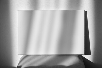 White canvas mockup on shelf on wall with shadows. Blank picture. Stretched canvas