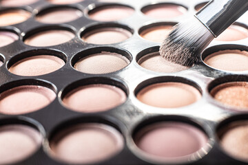 eye shadow is close. A makeup brush with eye shadow on it scatters the grains. macro palettes with...