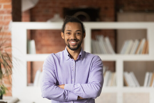 Portrait of smiling young handsome confident african american businessman entrepreneur worker employee posing in modern office room. Profile picture of motivated intelligent mixed race male teacher.