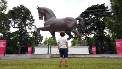 Europe, Italy , Milan June 2021 - Leonardo Da Vinci  horse statue and boy 6 years old visiting the sightseeing - art for children