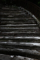 Old destroyed concrete staircase in the park. Close-up Signs of destruction. Vertical photo with grunge background.