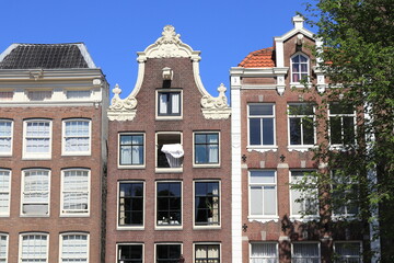 Fototapeta premium Amsterdam Canal House Facades with Duvet Airing From a Window