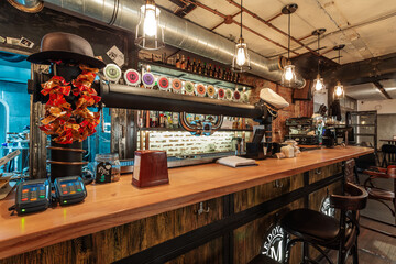 Trendy wooden bar counter with beer on tap