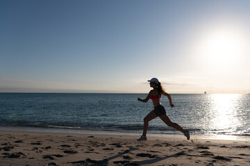 Fototapeta na wymiar Running is my favorite. Fit girl run along seaside. Woman runner. Trail running. Jogging activities