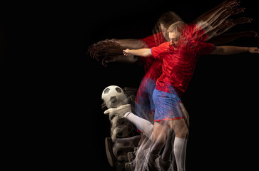 Non stop moving. Young caucasian football soccer player playing in motion in mixed light on dark background.
