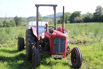 Obraz premium red tractor in the field