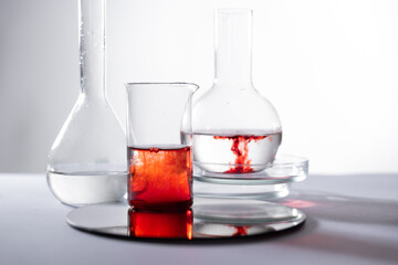drop of blood in a flask of liquid, laboratory studies of blood health, abstract medical background.