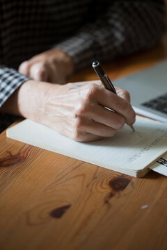Senior woman writing at home 
