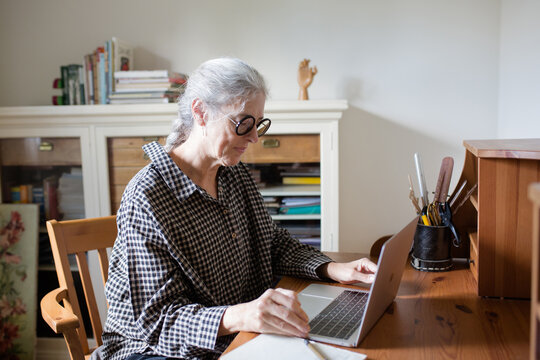 Senior woman working at home office
