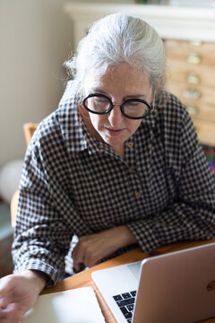Senior woman working at home office
