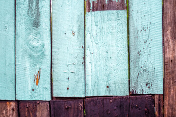 Vintage bright blue and brown planks with wood grains and nails forming the wooden background. Rustic textured wallpaper. Destroyed board border.