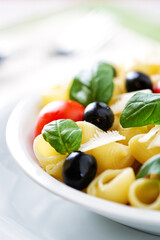 Fresh Pasta Salad with Tomatoes and Black Olives. High quality photo