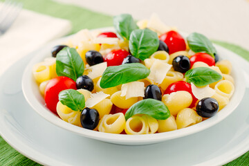 Fresh Pasta Salad with Tomatoes and Black Olives. High quality photo