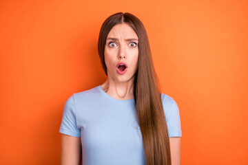 Photo of stressed long hairdo millennial lady open mouth wear blue t-shirt isolated on vivid orange...