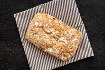 Fresh bread ciabatta loaf top view. Bakery background
