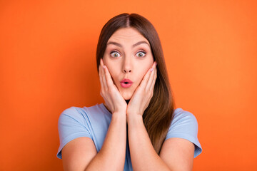 Photo of hooray brown hairdo young lady staring hands face wear blue t-shirt isolated on vivid...