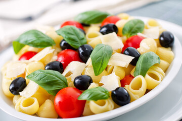 Fresh Pasta Salad with Tomatoes and Black Olives. High quality photo