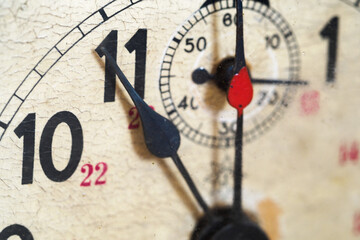 Detail of a dial with a hand on an old clock.