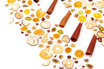 Close up of fruit lozenge different colors and almonds, orange, dried apricot, raisins, walnuts, dried apples and kiwi on white background. Concept of mixed dried fruits on table.