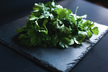fresh dill and parsley on a black board
