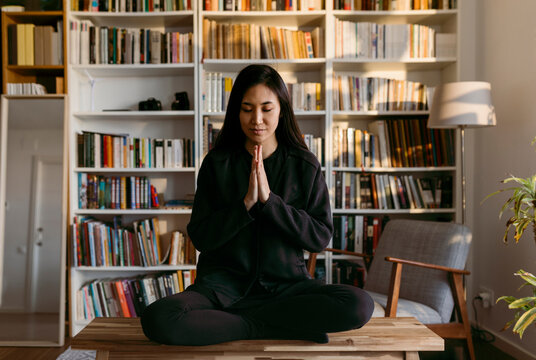 female east asian woman practicing mindfulness at home