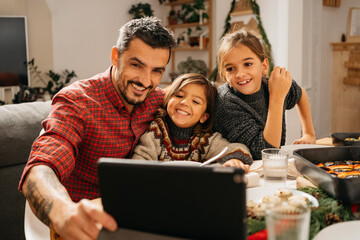 Family having a videocall during christmas dinner