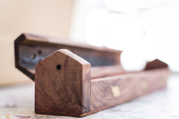 close up detail photography of wooden incense box with soft focus background 