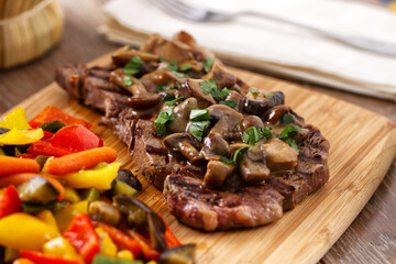 Grilled beefsteak with mushrooms and mixed vegetables.