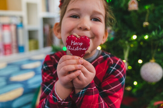 Little Girl with Red Heart Christmas Decoration - Powered by Adobe