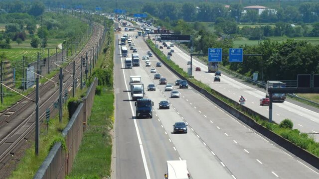 Weilbach, Germany - June 14, 2021: Large trucks and dense traffic on autobahn A3 near Wiesbadener Kreuz. The Bundesautobahn 3 (abbreviated as BAB 3 or A 3) is a highway in Germany that links the borde