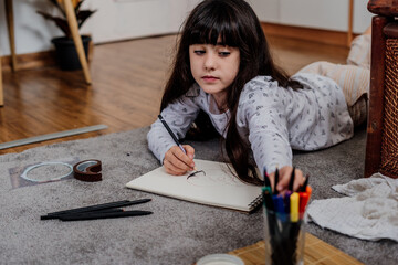 Little girl drawing at home