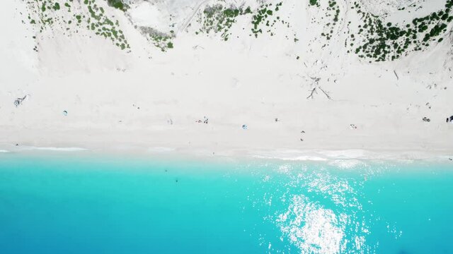 Drone shot of beautiful scenic beach with white sand and turquoise blue sea water, summer holiday in Greece, Egremni beach of Lefkada island.