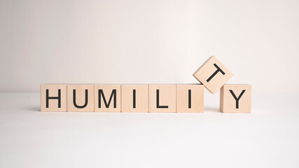 The word humility is written on wooden cubes on a light background. Business concept