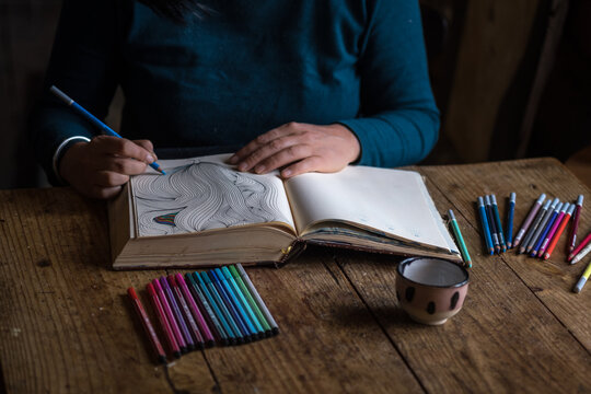 woman is making art in her sketchbook