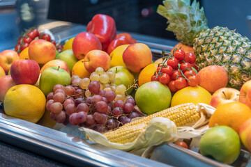 Group of different fruits and vegetables lies on kitchen table. Healthy eating. Side view. Selective focus. Buffet and catering service theme.