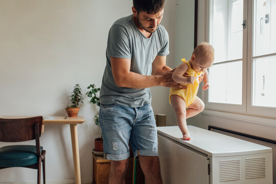 Dad Is Helping In Babies First Steps