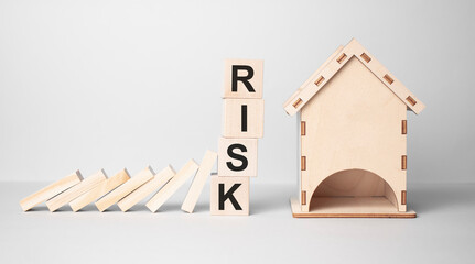 Red RISK cube blocks stop falling blocks protect house miniature. fall Business, Home Insurance, investment, Crisis, Economic recession
