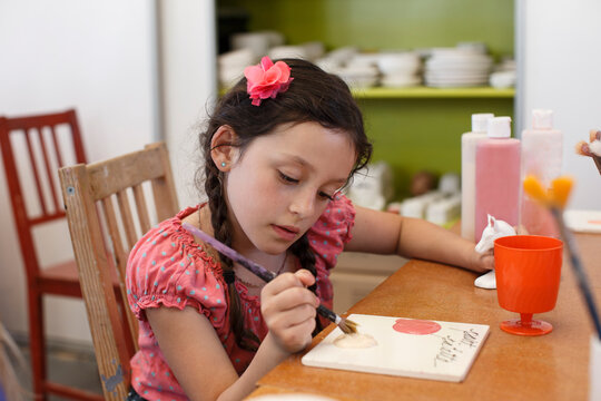 Young Girl Painting Pottery 