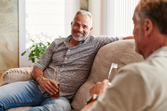 Smiling Mature Men Talking Over Beers