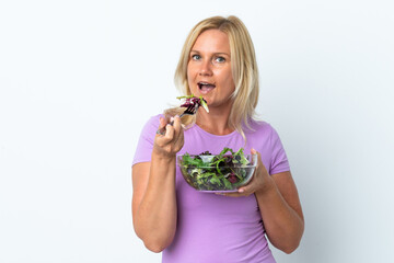 Middle age Lithuanian woman isolated on white background holding a bowl of salad with happy expression