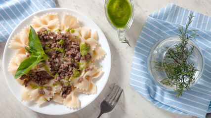 Delicious farfalle with freshly made pesto and minced meat.
