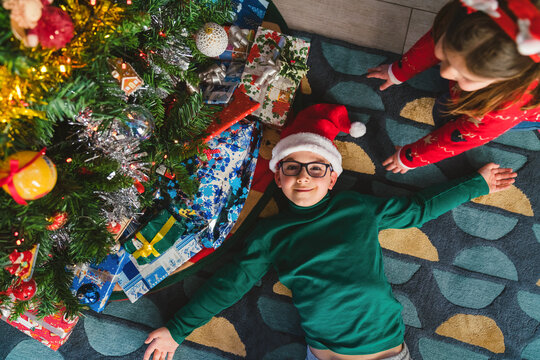 Siblings under the Christmas Tree