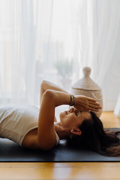 Relaxed woman meditating in supine pose