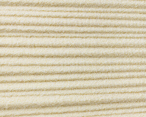 Raw dried semolina background, texture, horizontal grooves, top view