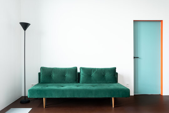 Minimalist living room with a green couch