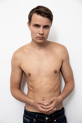 Fototapeta premium Portrait of handsome young and sexy man guy topless naked torso metrosexual hot tender body wear jeans isolated white background.