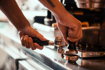 person working on a coffee maker machine