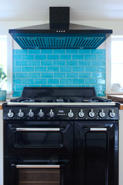 Large range style oven and cooktop in country kitchen
