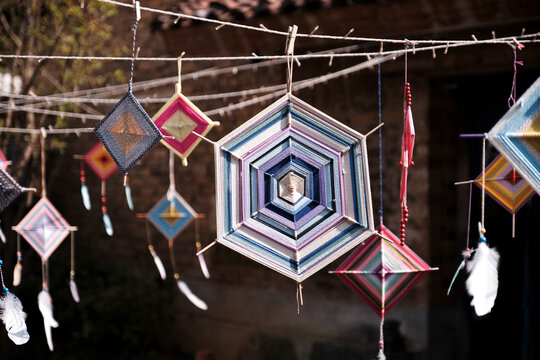 Hand-woven mandala dream catcher pattern, hung in the yard under the sun